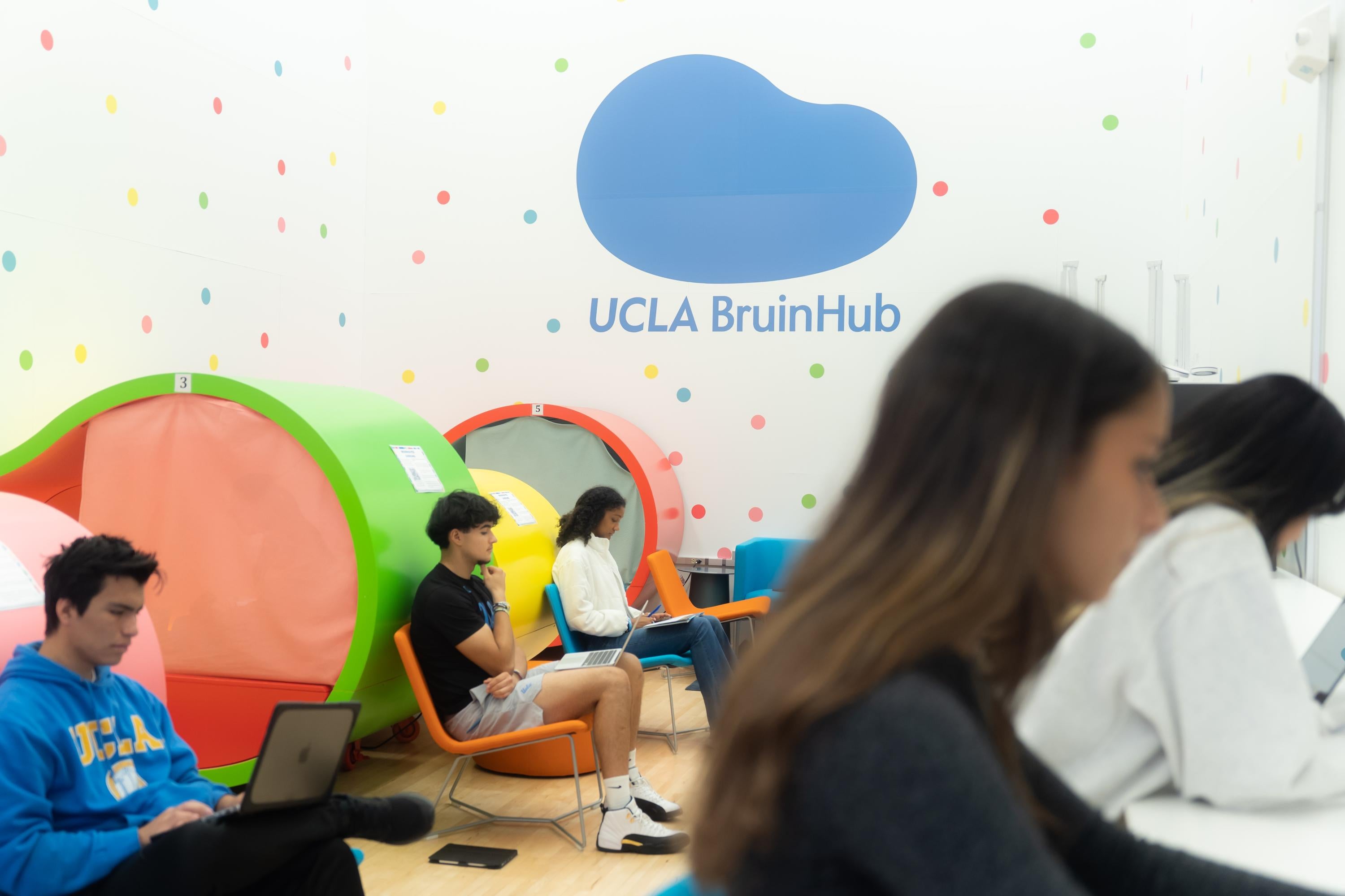 Students with their laptops sitting down in the JWC BruinHub